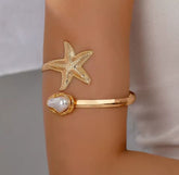 This gold-plated starfish and pearl arm cuff bracelet is often marketed as a boho beach statement piece.