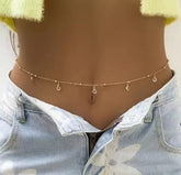 a gold-toned belly waist chain featuring delicate charms and circular accents.