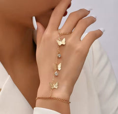 a gold-tone butterfly charm hand harness bracelet.