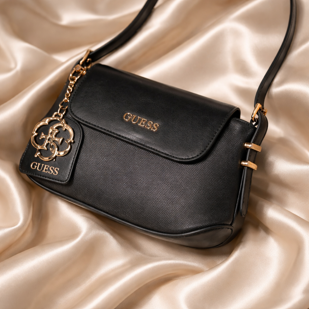 Guess faux-leather mini shoulder bag, possibly the Avelina model.  Dive deeper in AI