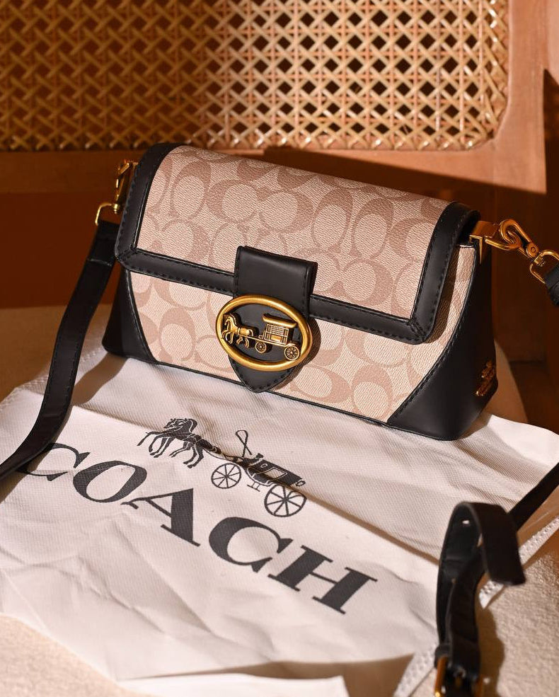 Coach Signature Studio Canvas Baguette Shoulder Bag in the tan and rust color variant.