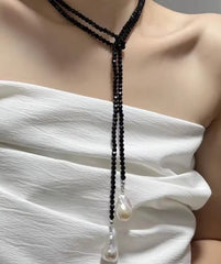 This item is a black crystal beaded lariat necklace featuring baroque pearl pendants, often referred to as a "Petra lariat" or a beaded bolero necklace.