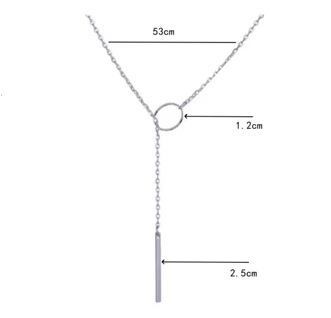 This product appears to be a minimal gold-plated lariat necklace featuring a circle and a vertical bar 