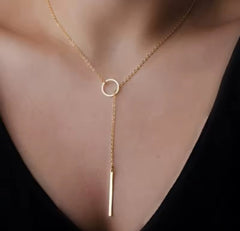 This product appears to be a minimal gold-plated lariat necklace featuring a circle and a vertical bar 