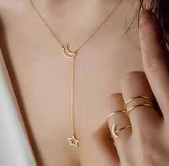 a gold-toned lariat necklace featuring a crescent moon pendant and a star charm, similar to styles from Larancie or Jewels Galaxy.