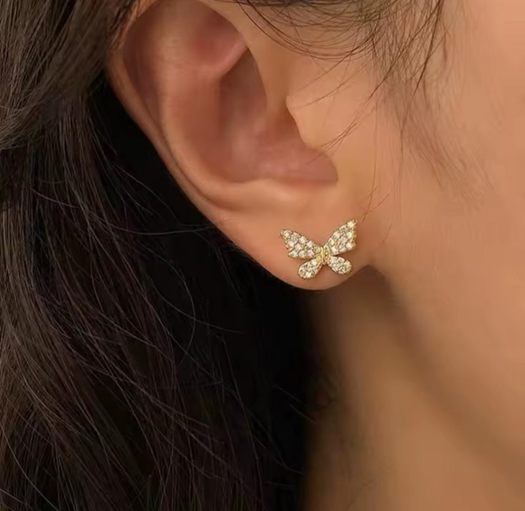 These earrings are described as Butterfly Pearl Earcuff Tassel Earrings, featuring a rhinestone-adorned butterfly stud connected to a cascading pearl chain ear cuff. 