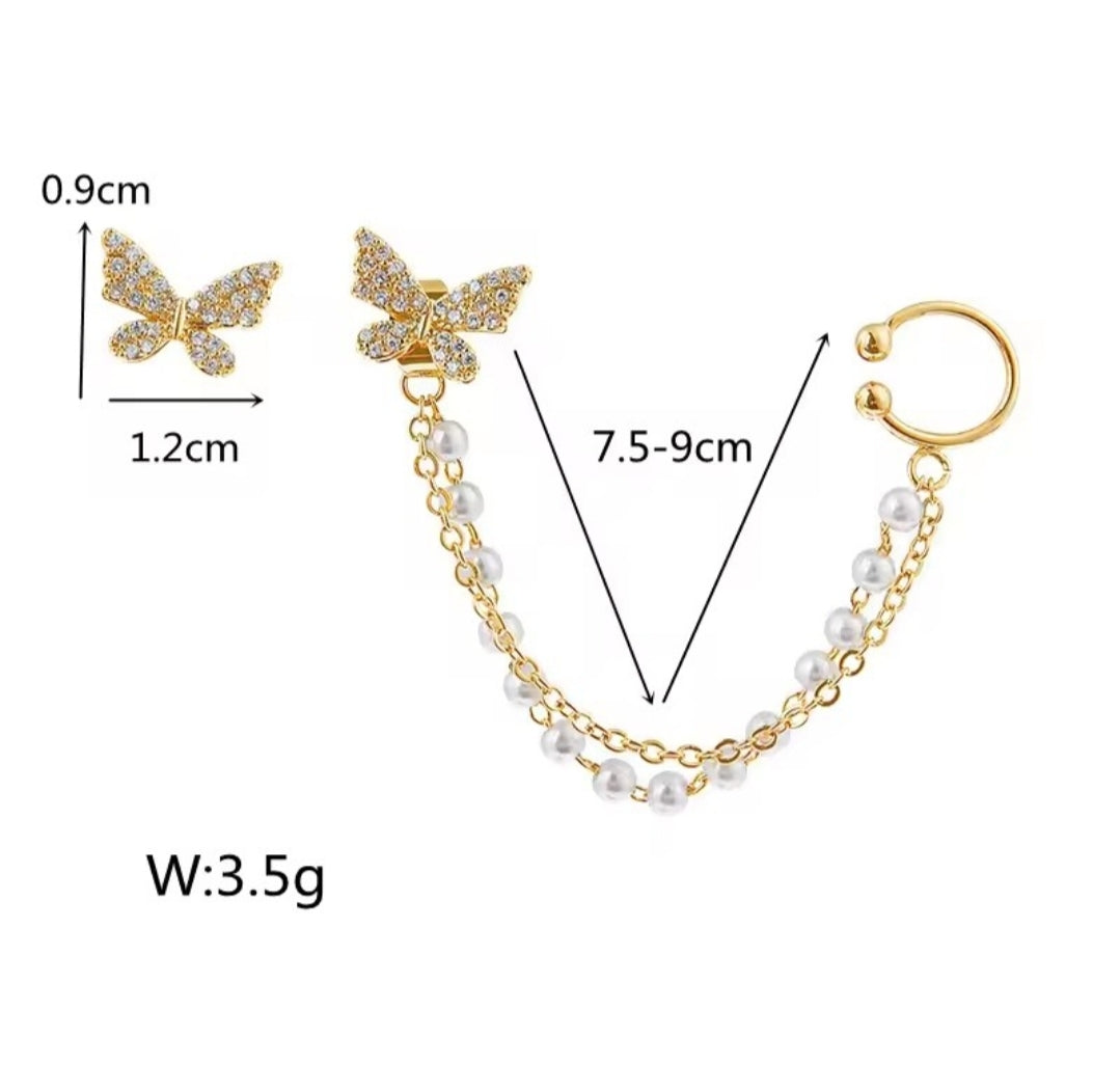 These earrings are described as Butterfly Pearl Earcuff Tassel Earrings, featuring a rhinestone-adorned butterfly stud connected to a cascading pearl chain ear cuff. 