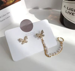 These earrings are described as Butterfly Pearl Earcuff Tassel Earrings, featuring a rhinestone-adorned butterfly stud connected to a cascading pearl chain ear cuff. 