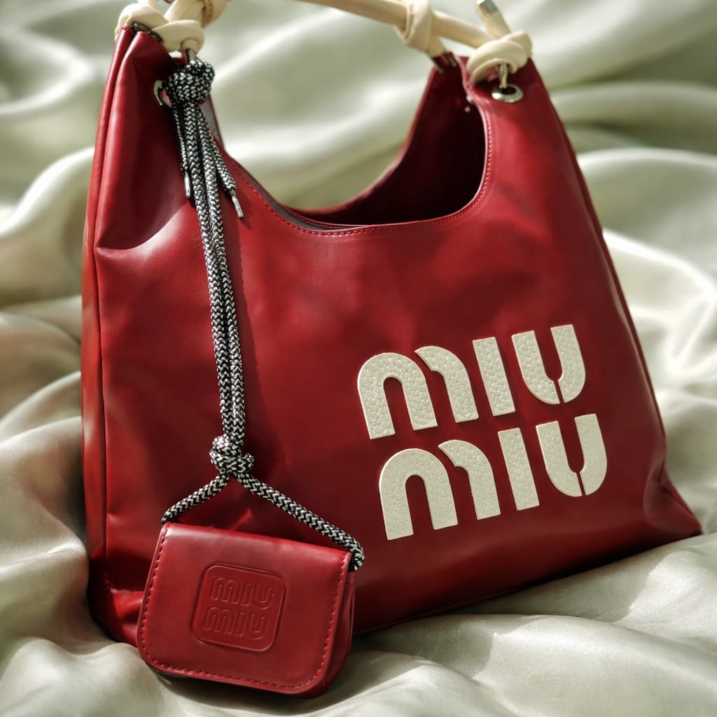red Miu Miu hobo bag with a matching micro bag charm.